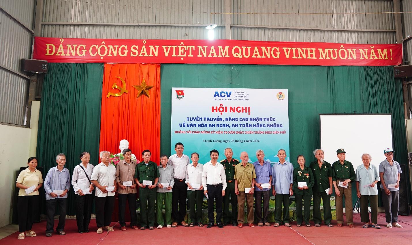 A group of people standing in front of a bannerDescription automatically generated