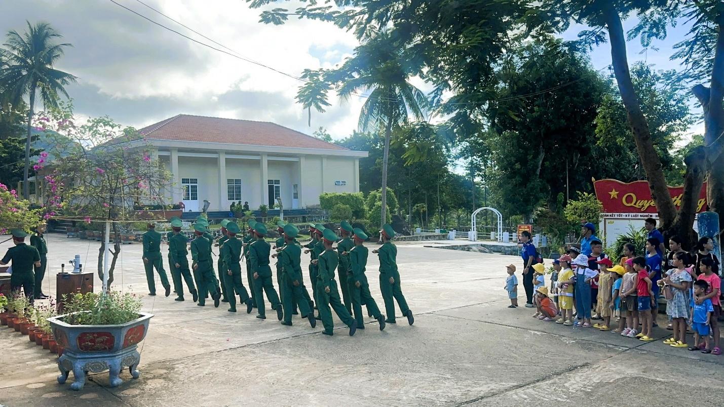A group of people marching in a paradeDescription automatically generated