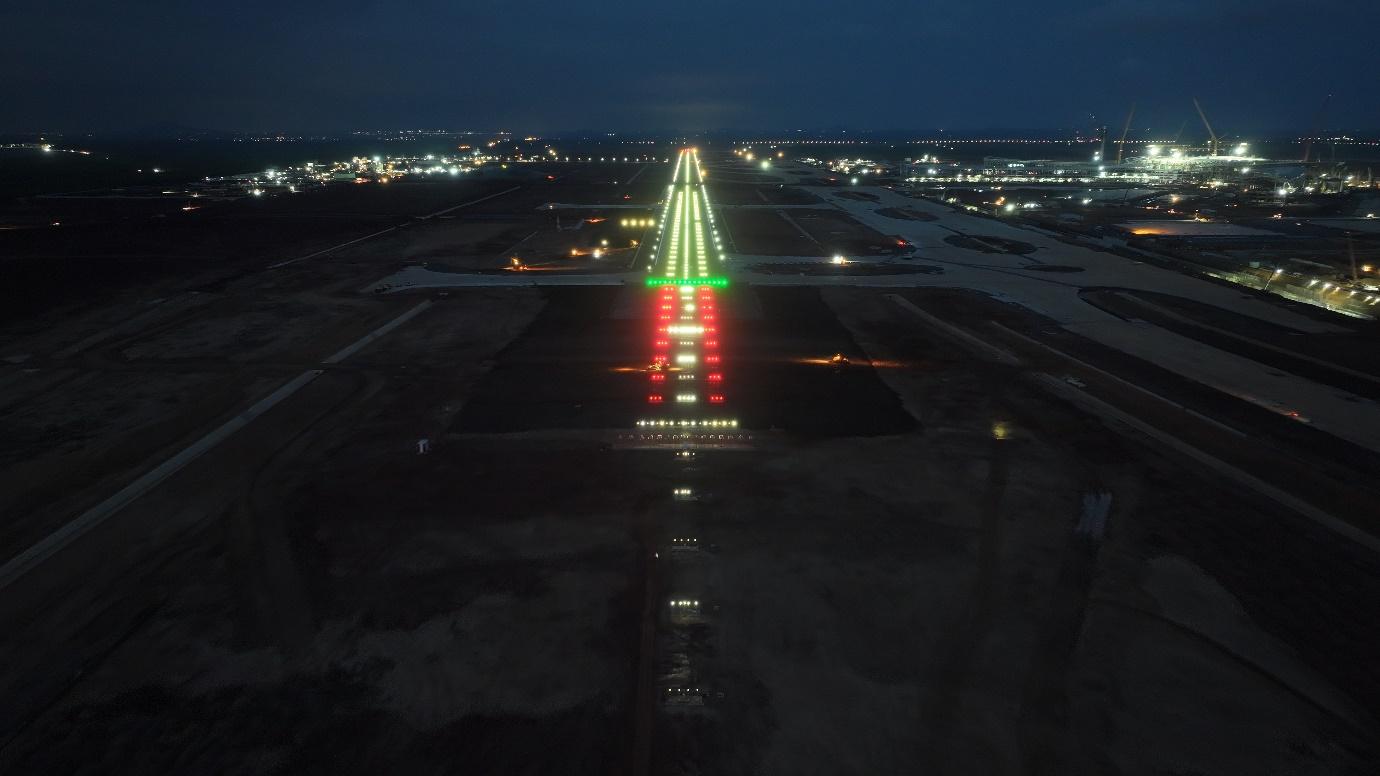 An aerial view of a runway at nightAI-generated content may be incorrect.