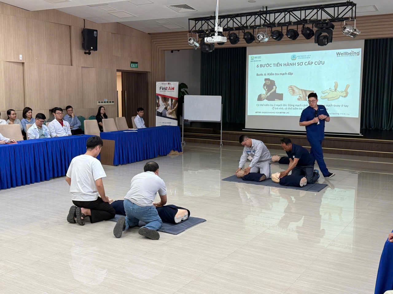 A group of people sitting on the floor in a room with a projector screenAI-generated content may be incorrect.