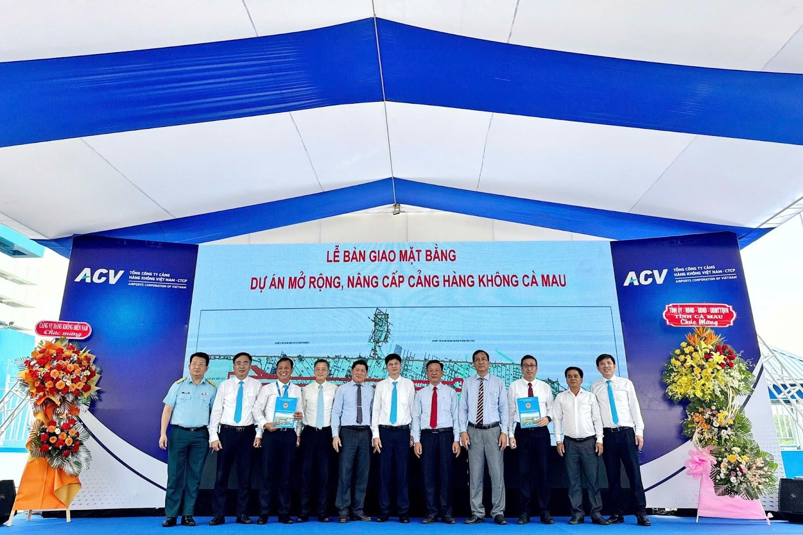 A group of people standing in front of a blue and white bannerAI-generated content may be incorrect.